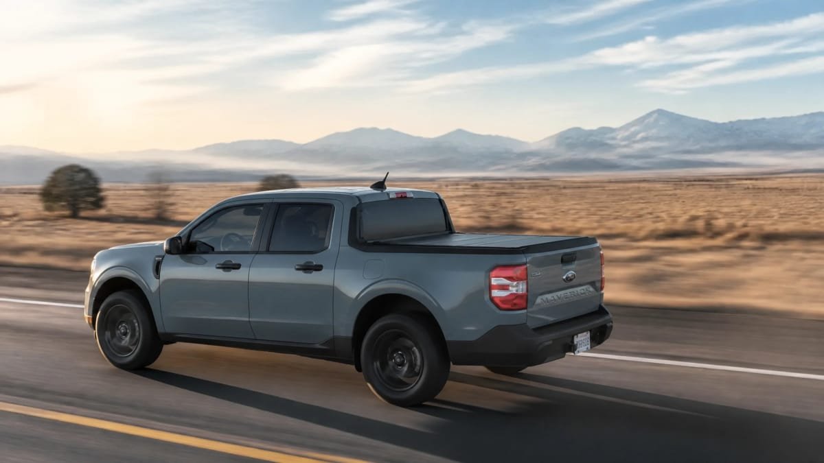 A sleek truck with a bed cover on a Colorado highway