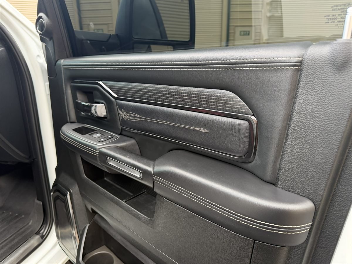 Leather door panel and armrest cleaned during an interior detail