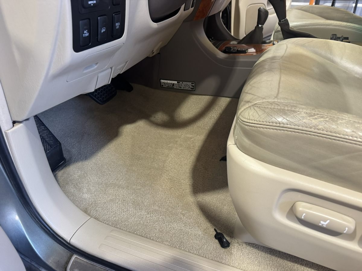 Driver footwell carpet cleaned and extracted during an interior detail